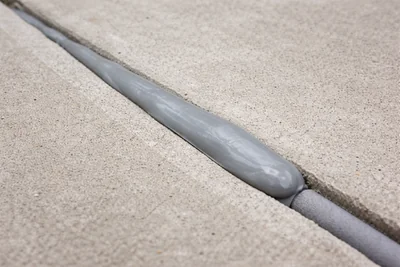 Gray polyurethane sealant in a concrete expansion joint with backer rod